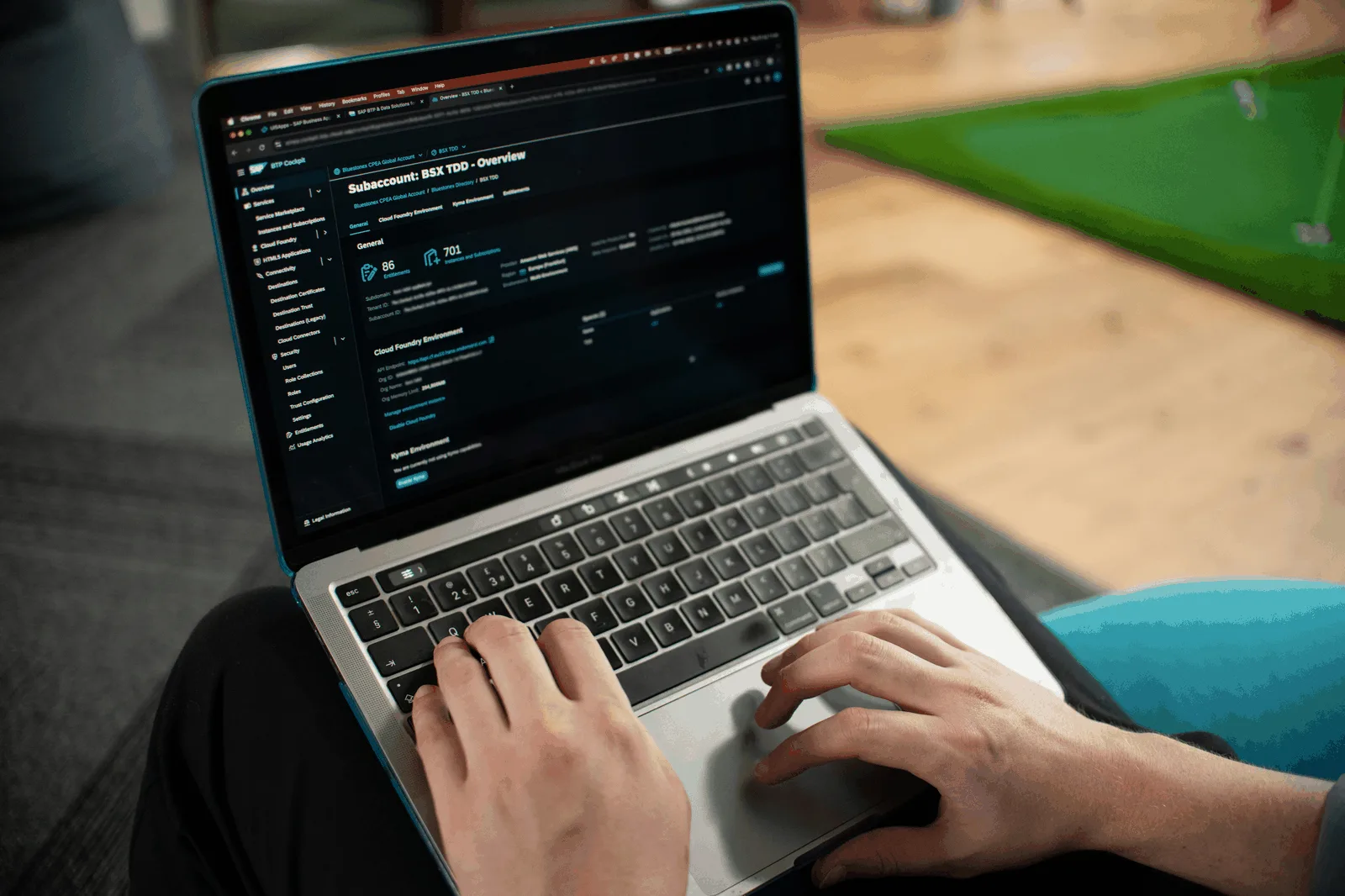 Hands typing on a laptop while working in a code editor