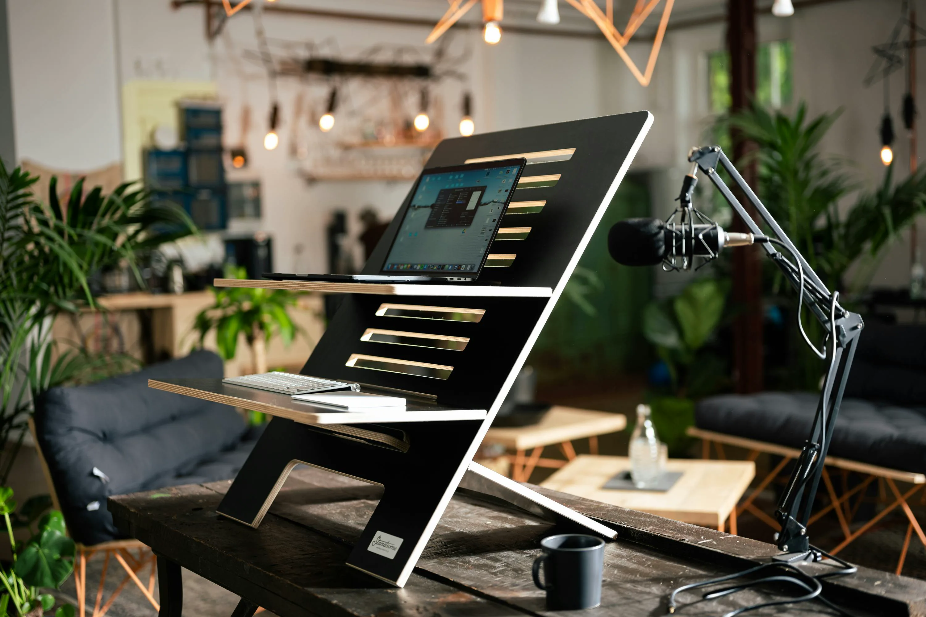 Workspace with laptop and podcast microphone